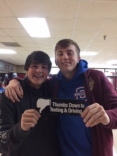 Boys holding Thumbs Down to Texting & Driver bumper sticker